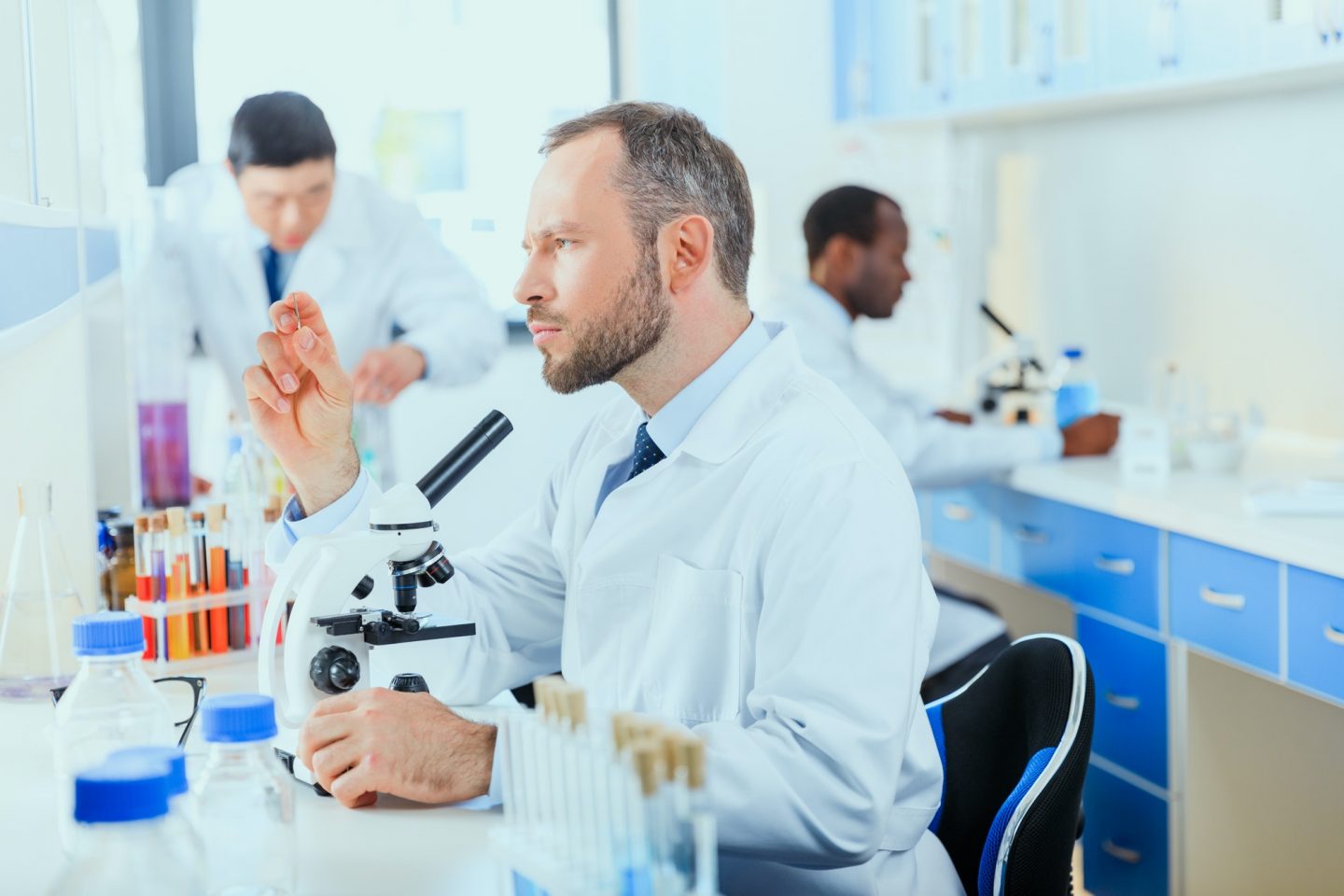 young doctors in uniform working at testing laboratory, laboratory technicians